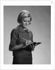 Blond woman secretary teacher taking notes by Anonymous
