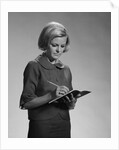 Blond woman secretary teacher taking notes by Anonymous