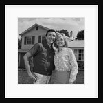 Happy couple portrait man woman smiling in front of home by Anonymous