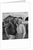 Happy couple portrait man woman smiling in front of home by Anonymous
