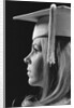 Profile blond female graduate wearing white mortarboard by Anonymous