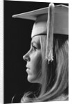 Profile blond female graduate wearing white mortarboard by Anonymous