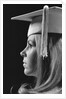 Profile blond female graduate wearing white mortarboard by Anonymous