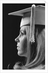 Profile blond female graduate wearing white mortarboard by Anonymous