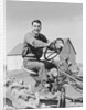 Smiling man farmer driving tractor by Anonymous