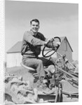 Smiling man farmer driving tractor by Anonymous