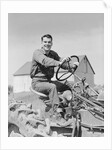Smiling man farmer driving tractor by Anonymous