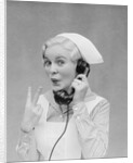 Smiling blond nurse with surprised expression talking on telephone holding up two fingers by Anonymous