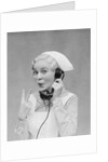Smiling blond nurse with surprised expression talking on telephone holding up two fingers by Anonymous