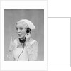 Smiling blond nurse with surprised expression talking on telephone holding up two fingers by Anonymous