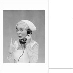 Smiling blond nurse with surprised expression talking on telephone holding up two fingers by Anonymous