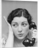 Young brunette woman with surprised expression hand to head talking on telephone by Anonymous