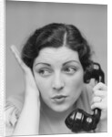 Young brunette woman with surprised expression hand to head talking on telephone by Anonymous