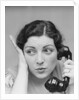 Young brunette woman with surprised expression hand to head talking on telephone by Anonymous