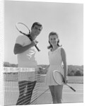 Portrait tennis couple man woman holding racquets standing by net by Anonymous