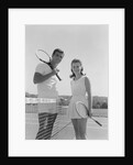 Portrait tennis couple man woman holding racquets standing by net by Anonymous