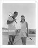 Portrait tennis couple man woman holding racquets standing by net by Anonymous