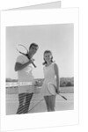 Portrait tennis couple man woman holding racquets standing by net by Anonymous