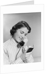 Young woman talking on telephone reading address from little black book by Anonymous