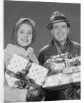 Couple man and woman holding wrapped christmas presents and packages by Anonymous
