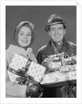 Couple man and woman holding wrapped christmas presents and packages by Anonymous