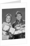 Couple man and woman holding wrapped christmas presents and packages by Anonymous