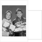 Couple man and woman holding wrapped christmas presents and packages by Anonymous