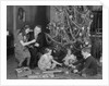 Family christmas photo father two daughters and son with presents and tree by Anonymous