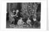 Family christmas photo father two daughters and son with presents and tree by Anonymous
