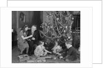 Family christmas photo father two daughters and son with presents and tree by Anonymous