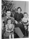 Family portrait by christmas tree by Anonymous