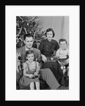 Family portrait by christmas tree by Anonymous