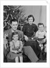 Family portrait by christmas tree by Anonymous