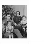 Family portrait by christmas tree by Anonymous