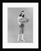 Young woman wearing santa claus hat hot pants go-go boots holding wrapped christmas presents by Anonymous