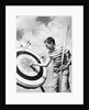 Boy jeans striped t-shirt holding bow & pulling arrow out of target bull's-eye by Anonymous