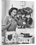 Housewife tasting with spoon by stove funny facial expression by Anonymous