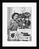 Housewife tasting with spoon by stove funny facial expression by Anonymous