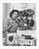Housewife tasting with spoon by stove funny facial expression by Anonymous