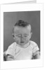 Portrait baby with eyes tightly closed by Anonymous