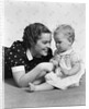 Woman mother smiling sitting playing with baby daughter by Anonymous