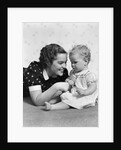 Woman mother smiling sitting playing with baby daughter by Anonymous