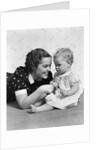 Woman mother smiling sitting playing with baby daughter by Anonymous