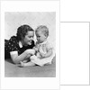 Woman mother smiling sitting playing with baby daughter by Anonymous