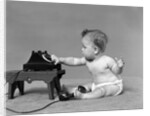 Baby in diaper dialing telephone by Anonymous