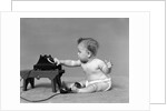 Baby in diaper dialing telephone by Anonymous