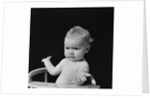 Baby in high chair making shrugging gesture by Anonymous