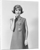 Smiling stylish young woman wearing sack dress gloves by Anonymous