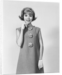 Smiling stylish young woman wearing sack dress gloves by Anonymous