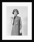 Smiling stylish young woman wearing sack dress gloves by Anonymous
